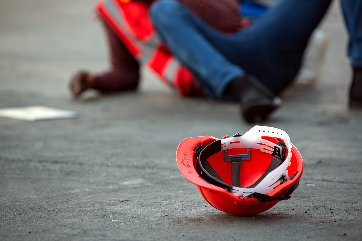 Red hard safety helmet hat for engineer on concrete ground - Crédit: Thanumporn/AdobeStock