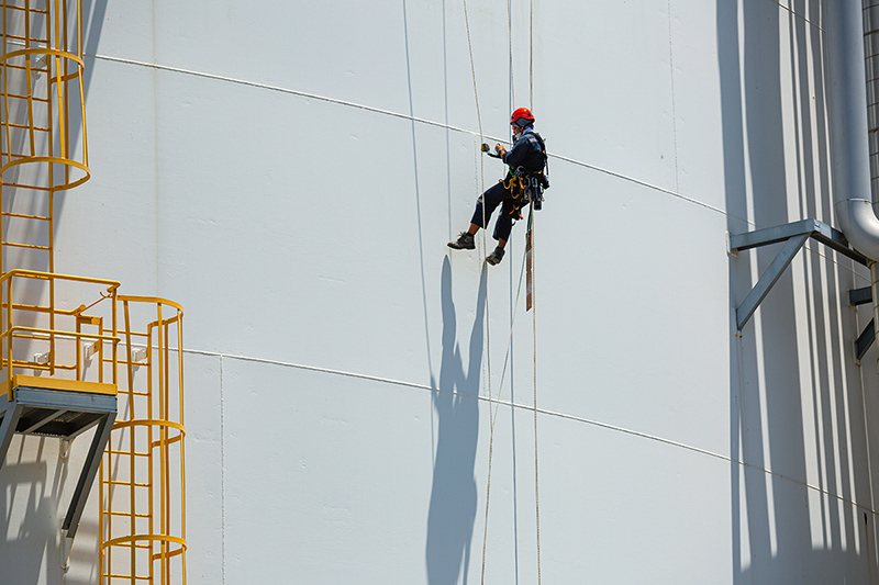 Male worker down height tank shell plate rope ladder - Crédit: Chitsanupong/AdobeStock